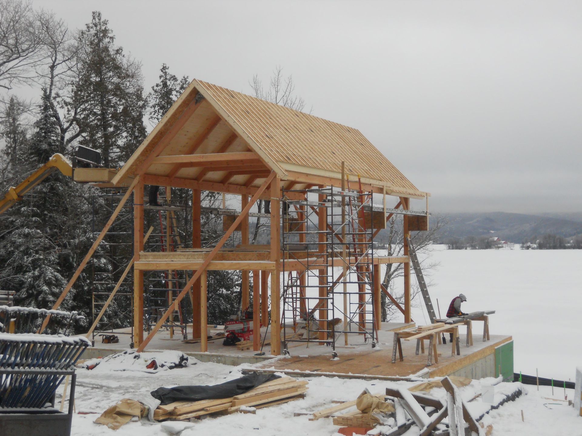 A wooden structure is being built in the snow