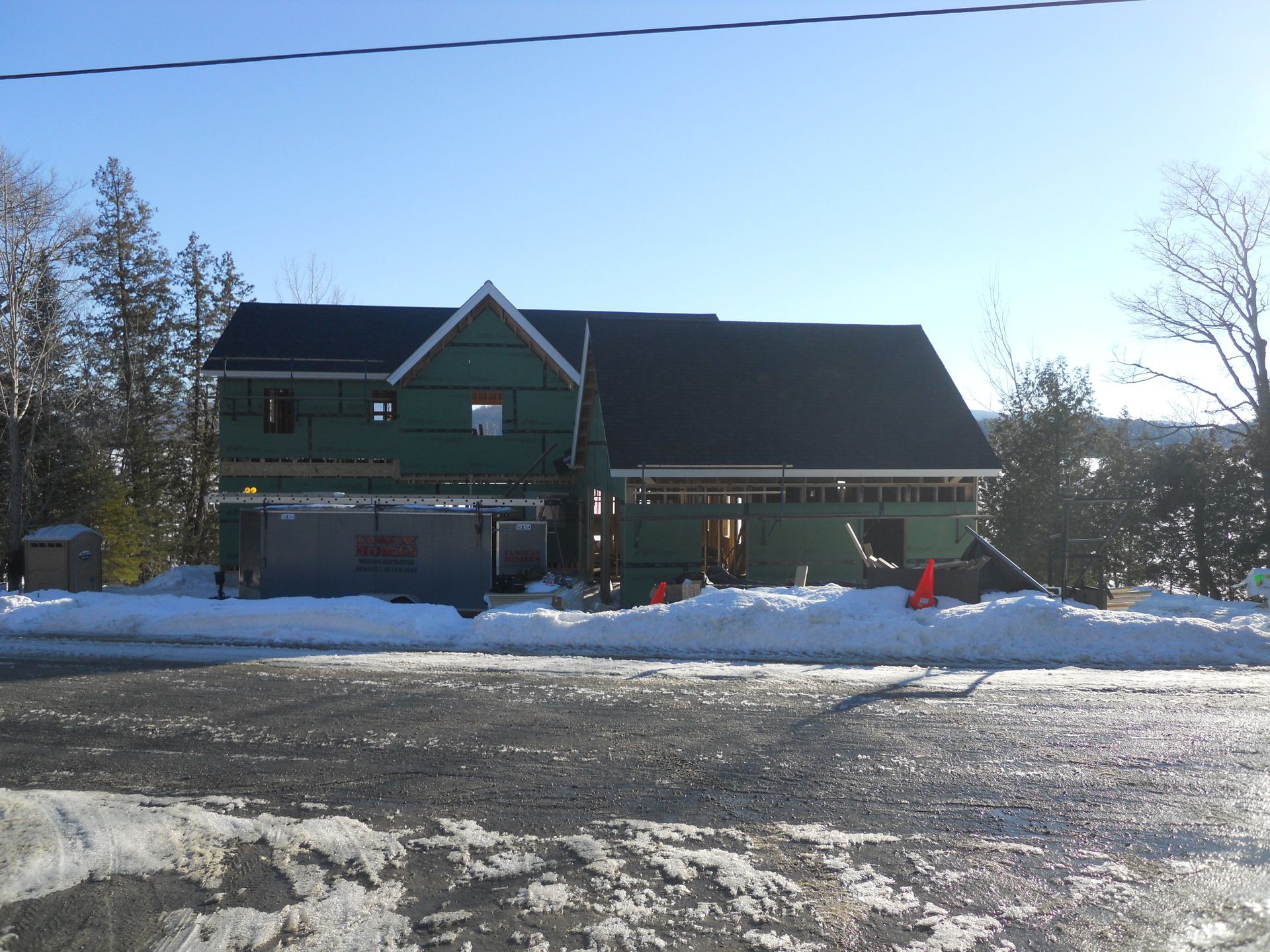 A house that is being built in the snow with a sign that says lms