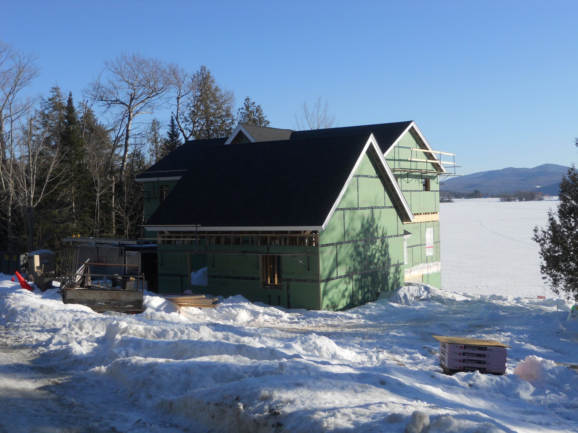 A green house is being built in the snow