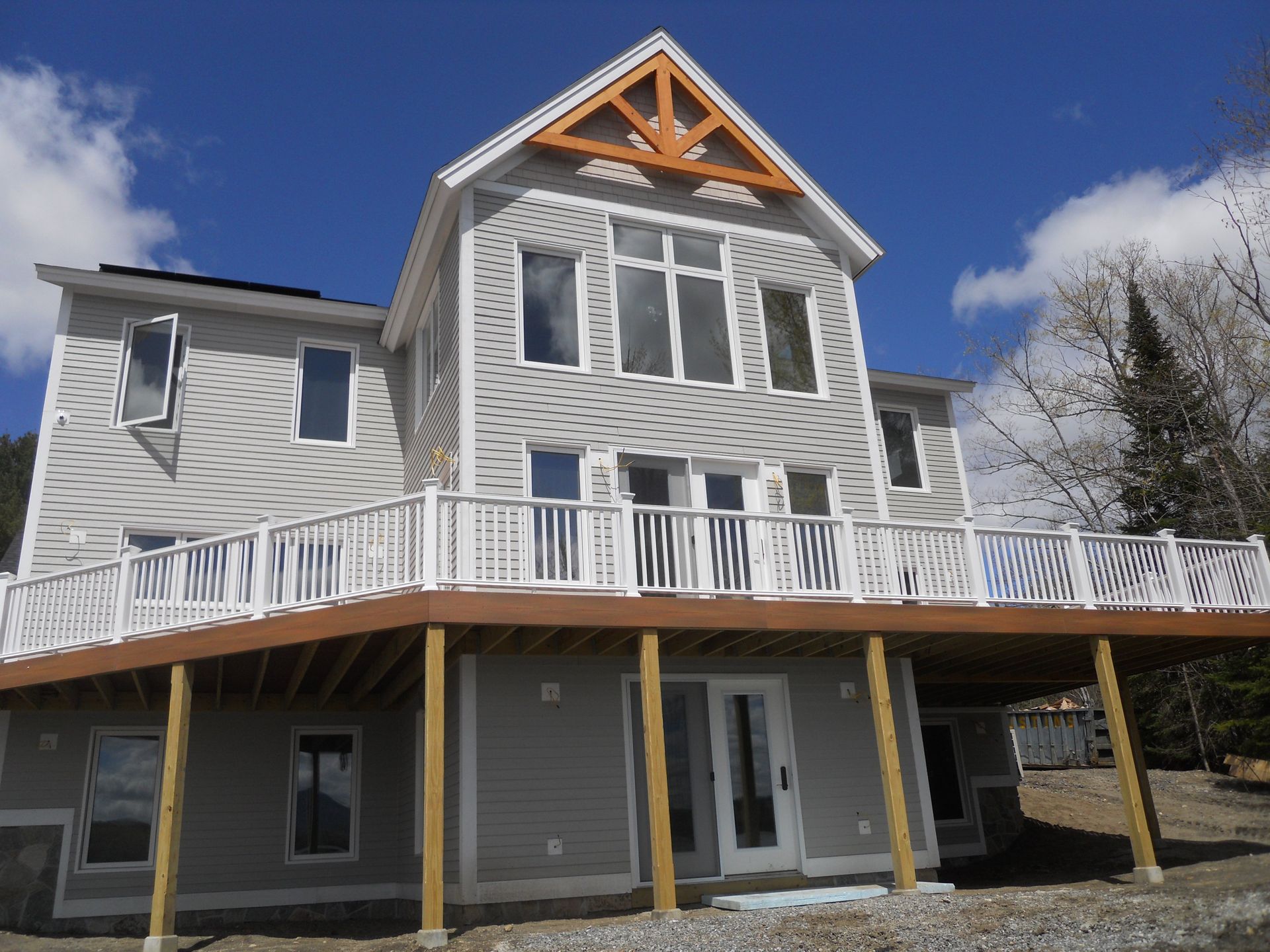 A large white house with a large deck