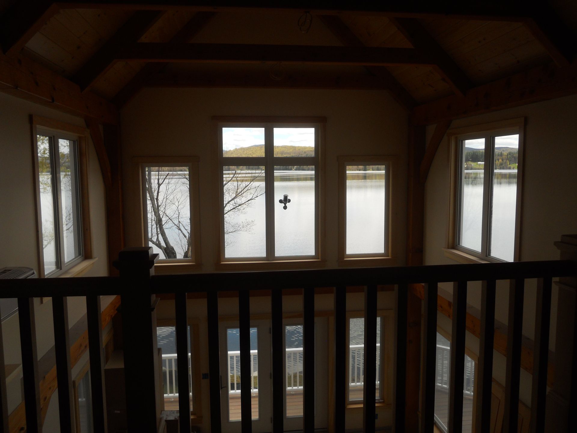 A view of a lake from a balcony in a house