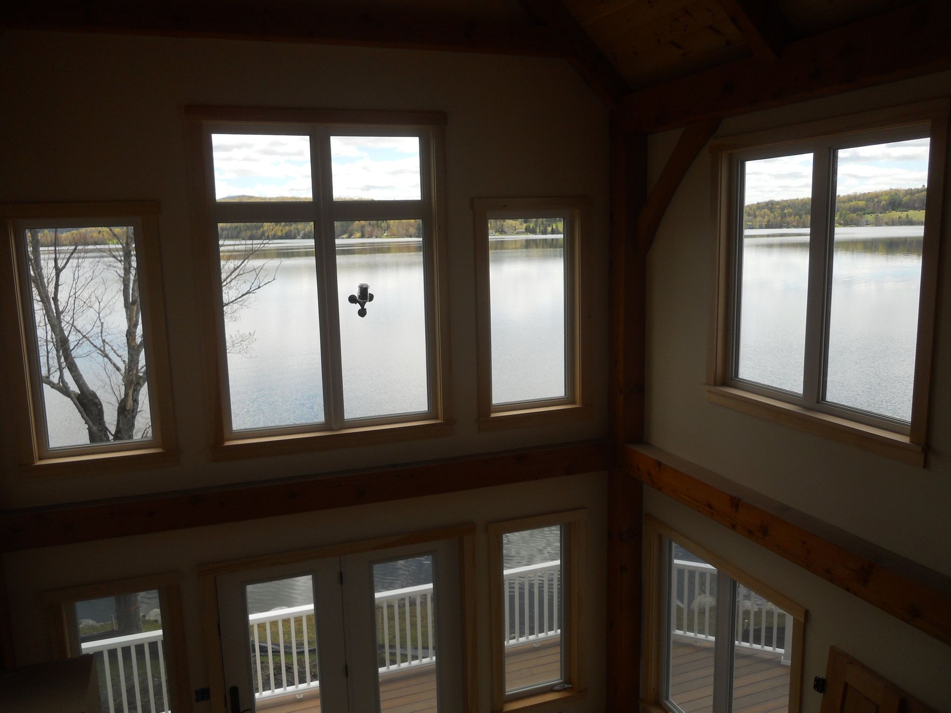 A house with lots of windows looking out to a lake