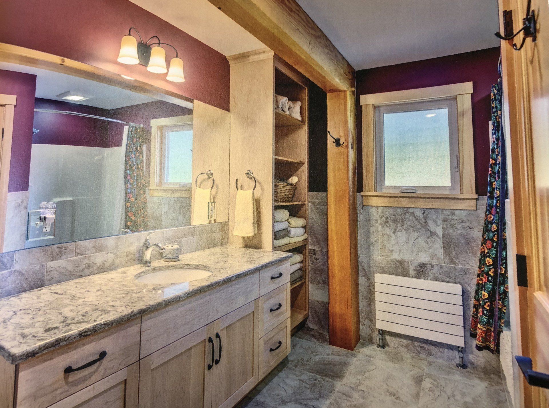 A bathroom with two sinks and a large mirror