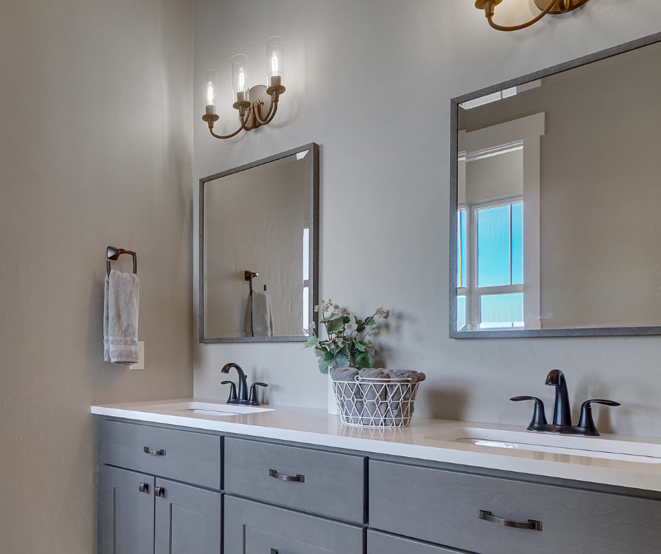 A bathroom with two sinks and two mirrors.