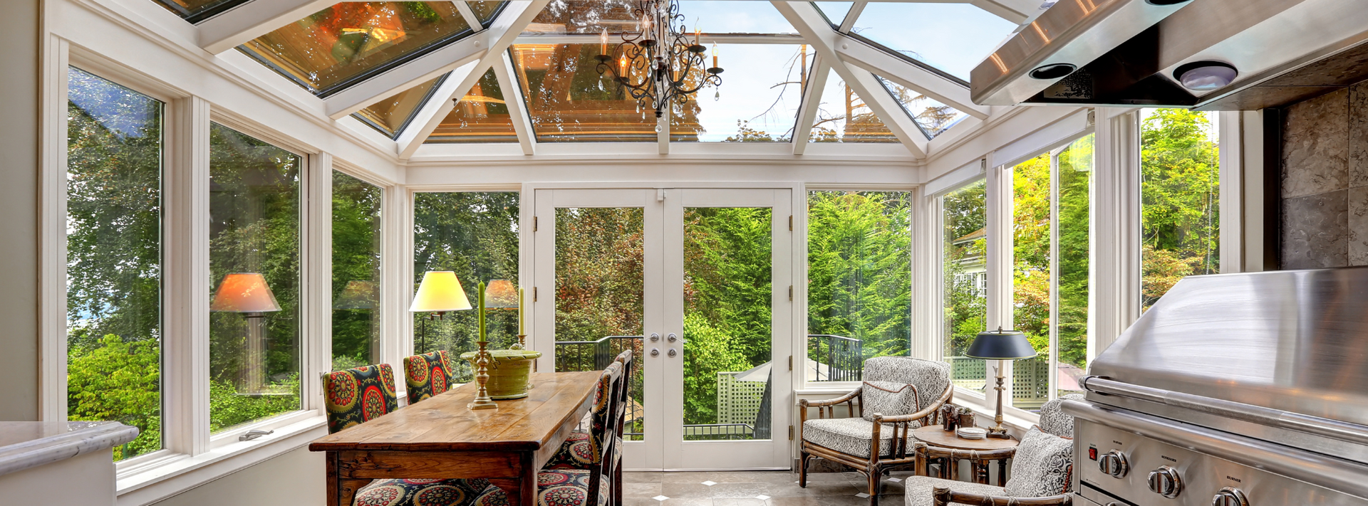 A sunroom with a dining table, chairs and a grill in Vermont