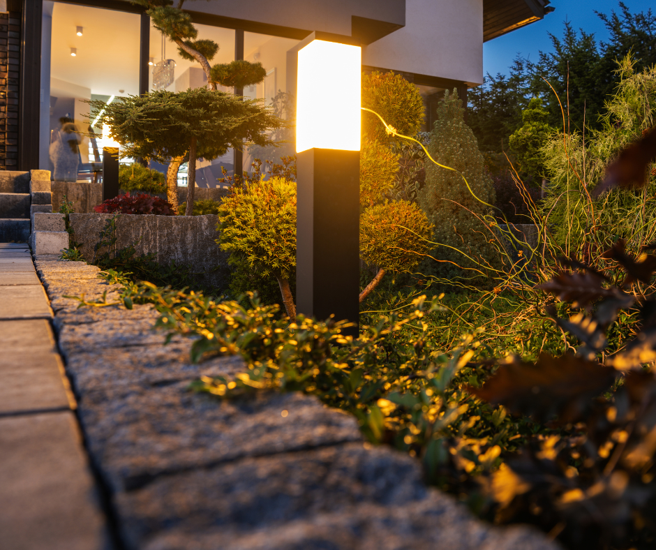 An outdoor light illuminating a pathway in a Vermont home's garden