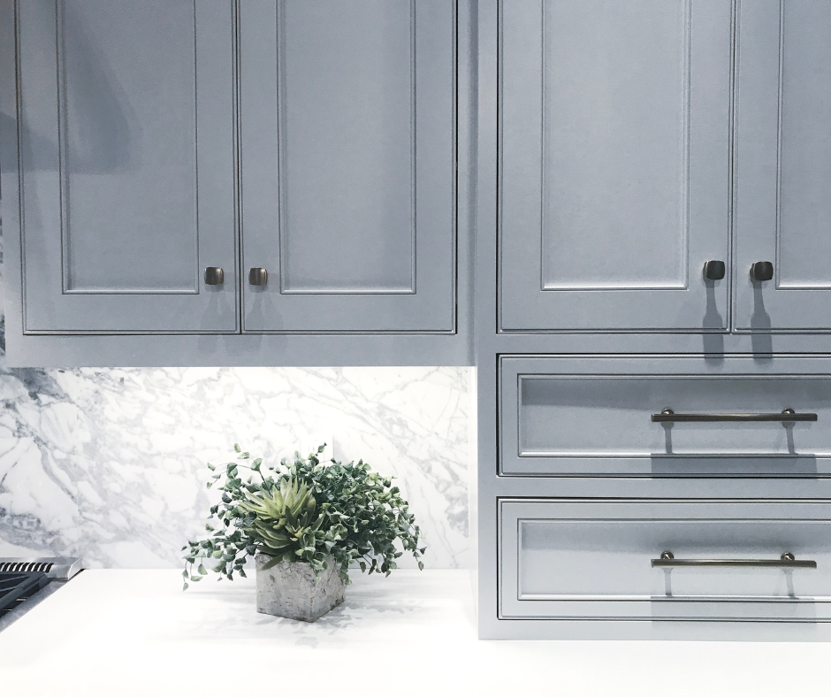 Blue shaker cabinets with a marble backsplash in a Vermont kitchen.