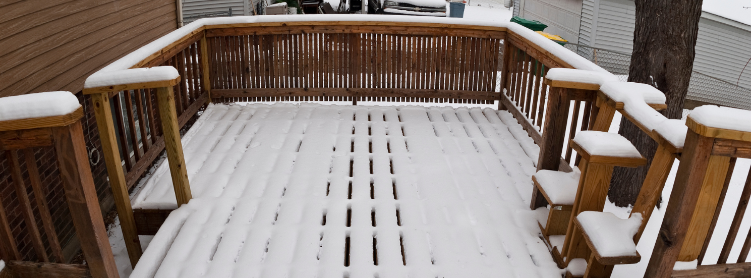 A wooden deck covered in snow in Vermont.