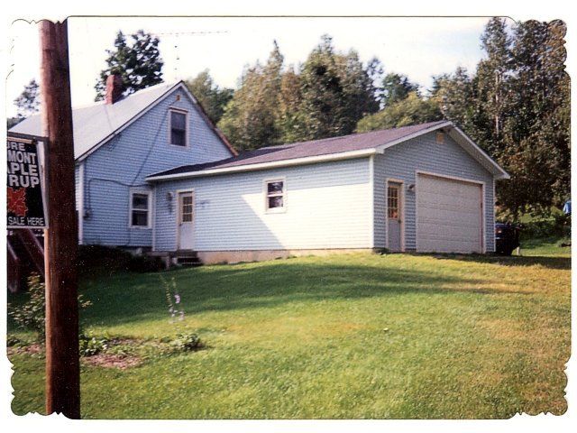 A house with a garage and a sign that says west maple ruf