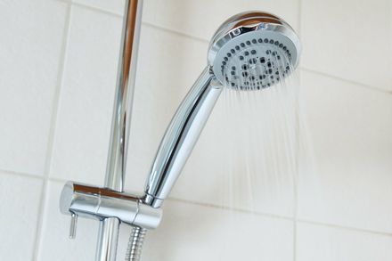 metal shower head with water coming out