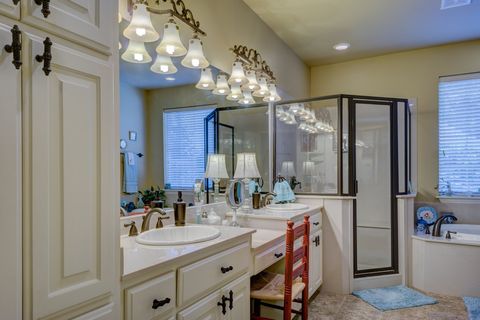 bathroom vanity with shower and light fixtures