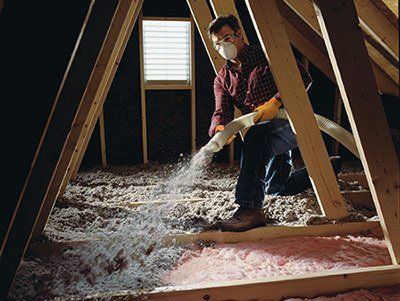 A Professional spraying insulation in an attic