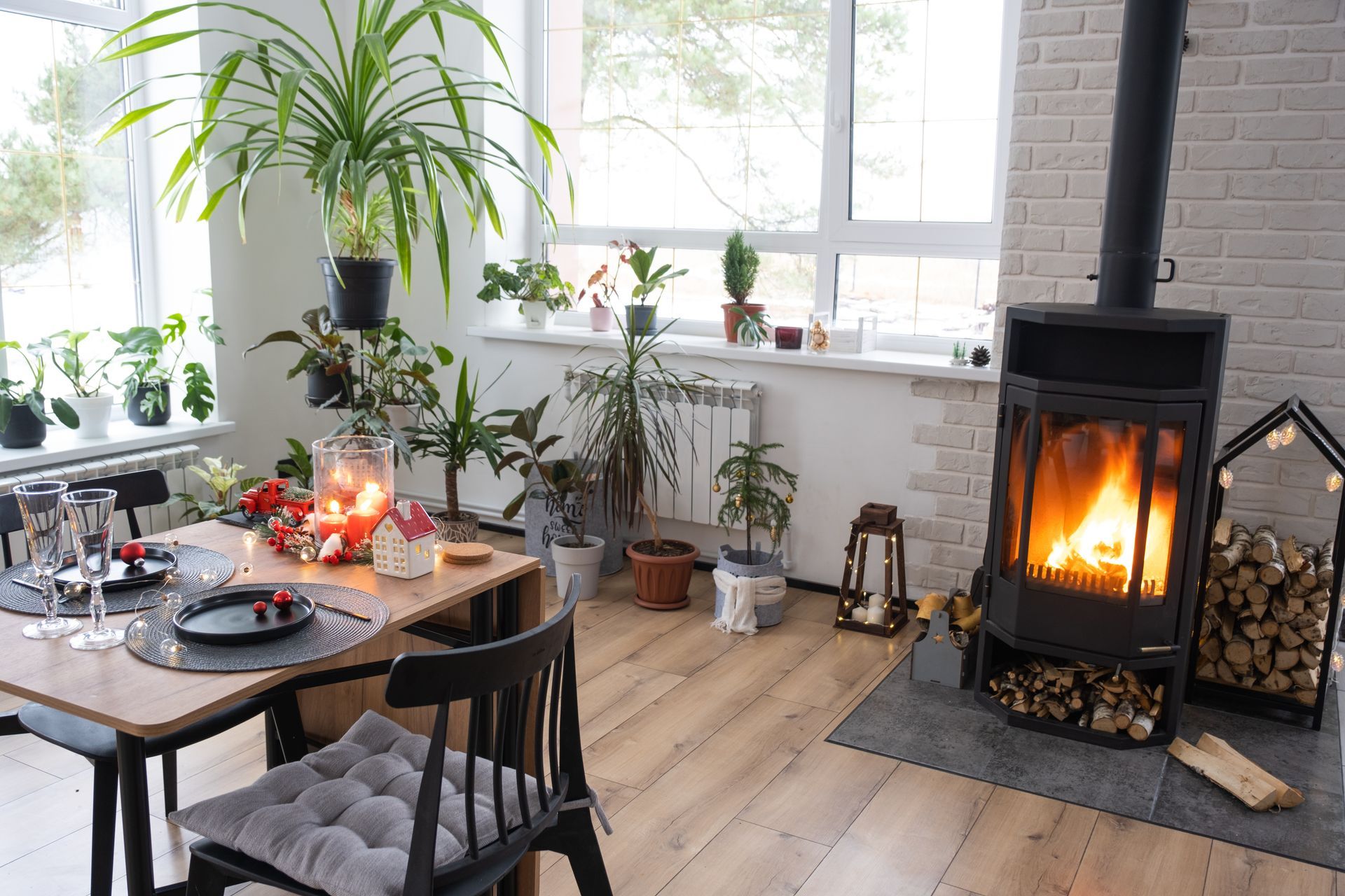 A cozy living room with a table and chairs and a fireplace renovated by Tanguay Homes