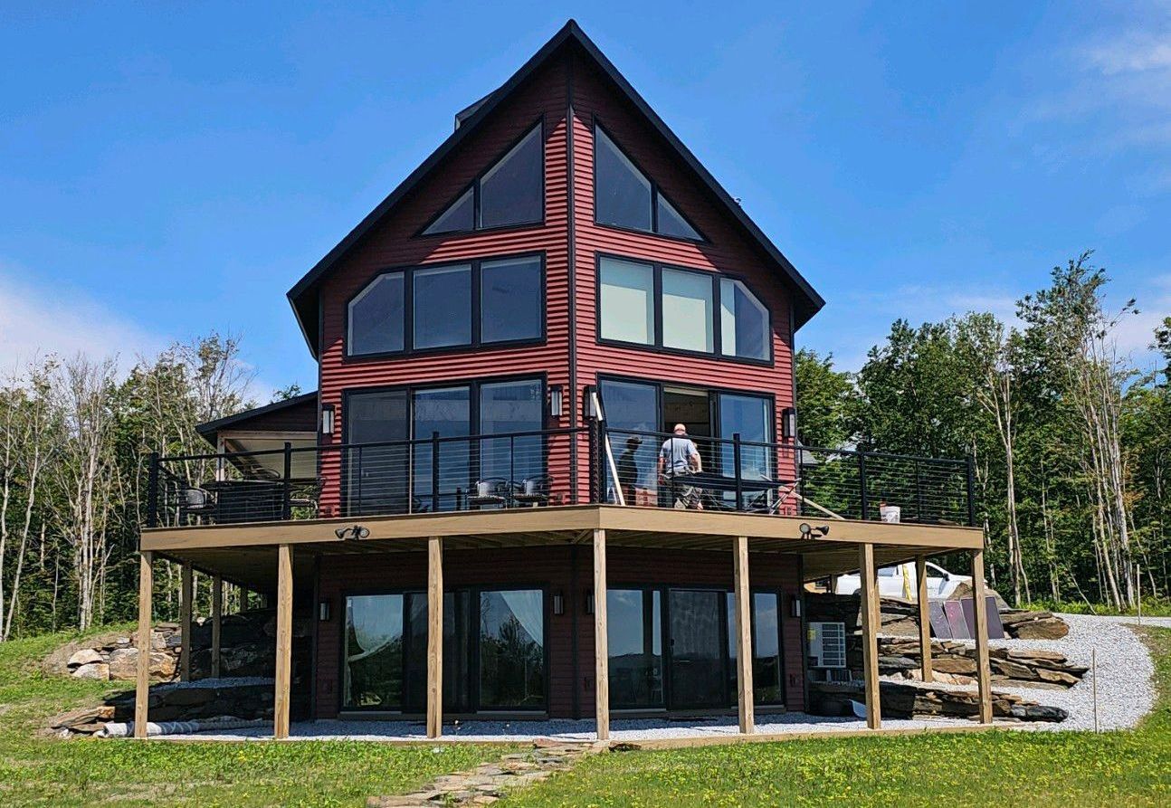 A large red house in Vermont with a lot of windows