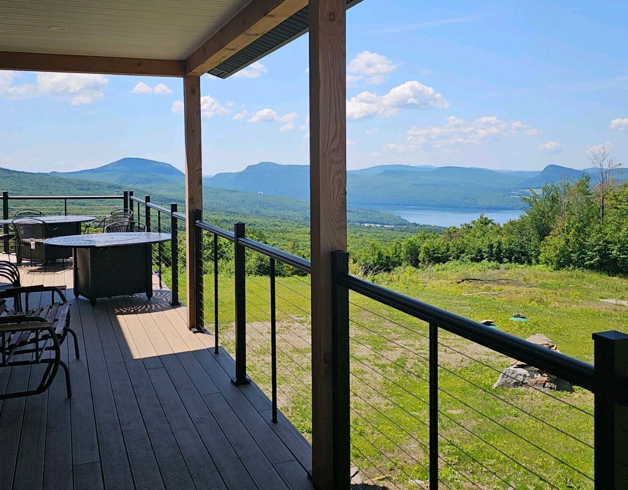 A deck with a view of a lake and mountains in Vermont.