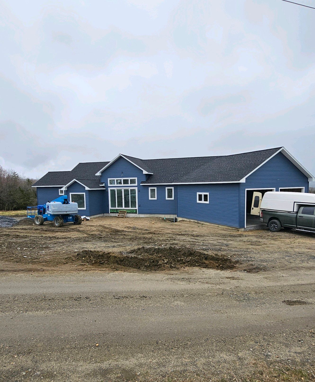 A beautiful blue home newly constructed in Sutton, Vermont, built by Tanguay Homes