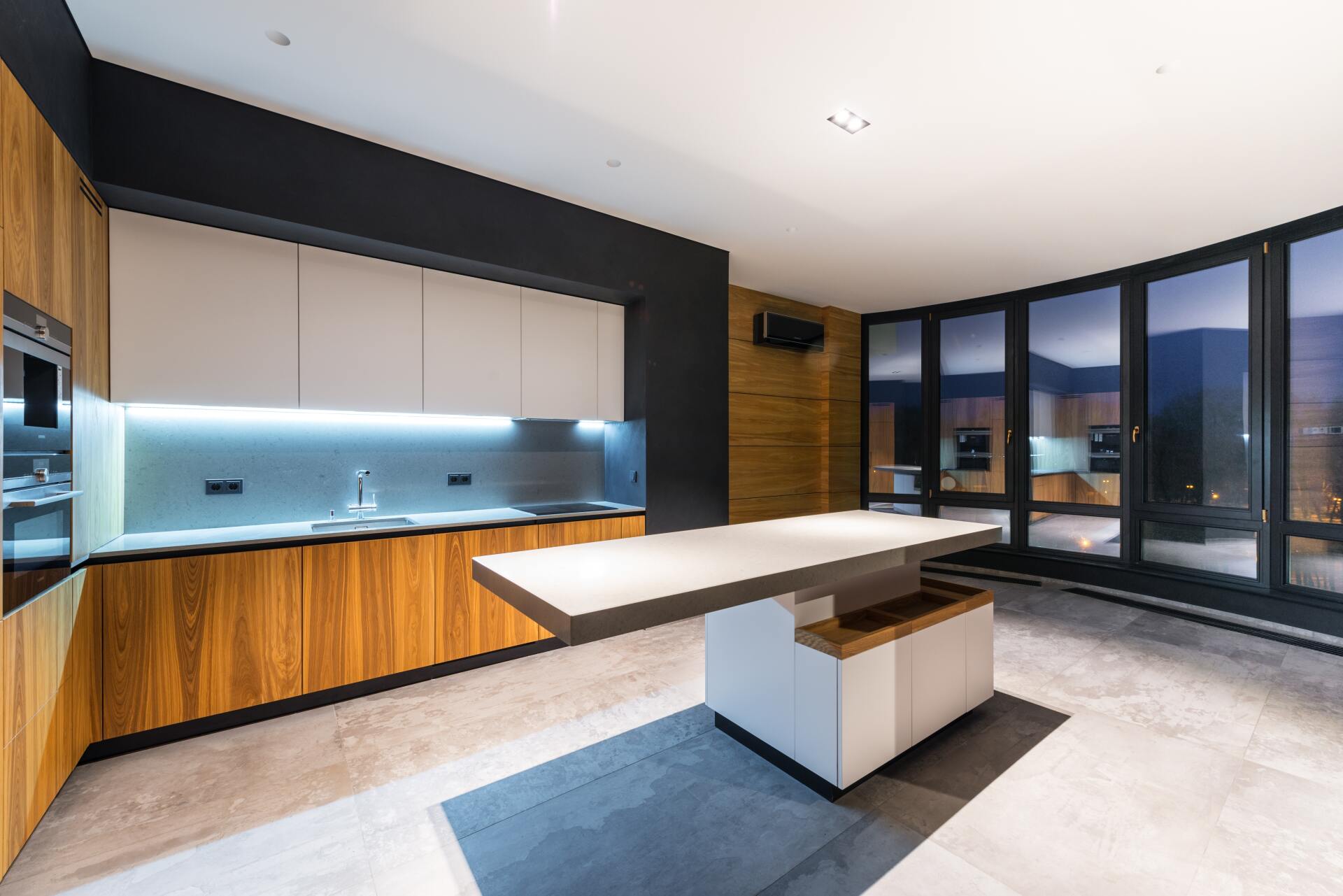 A modern kitchen with under cabinet lighting