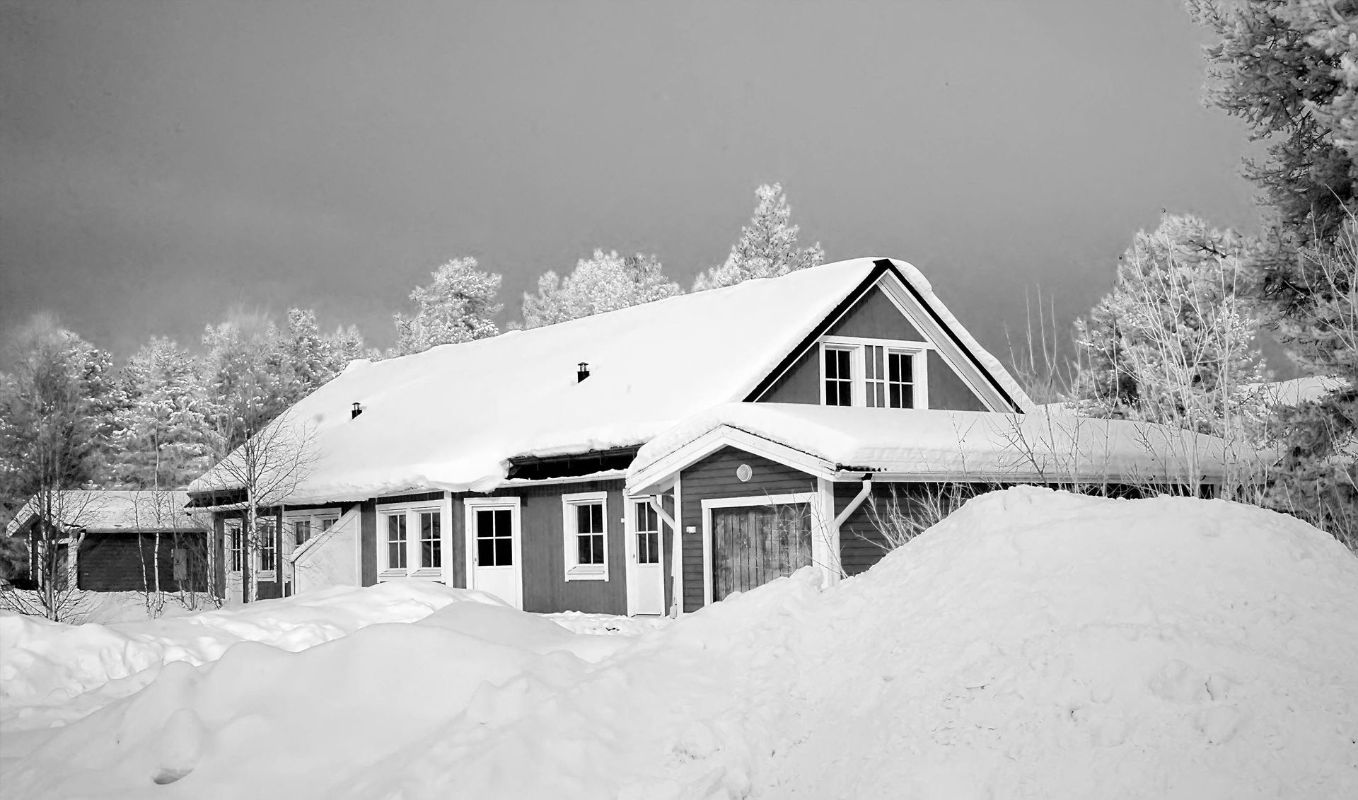 A grey house covered in snow in Vermont