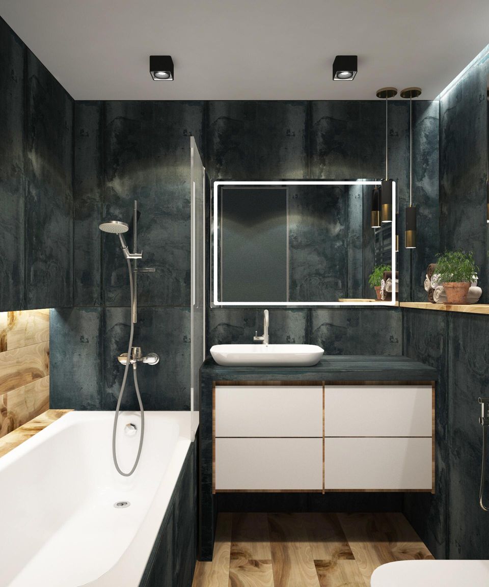 modern bathroom with a bathtub and vanity and deep green tile