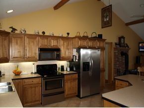 A kitchen with stainless steel appliances and wooden cabinets