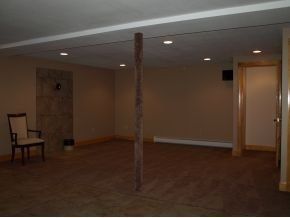 An empty room with a chair and a pole in the middle