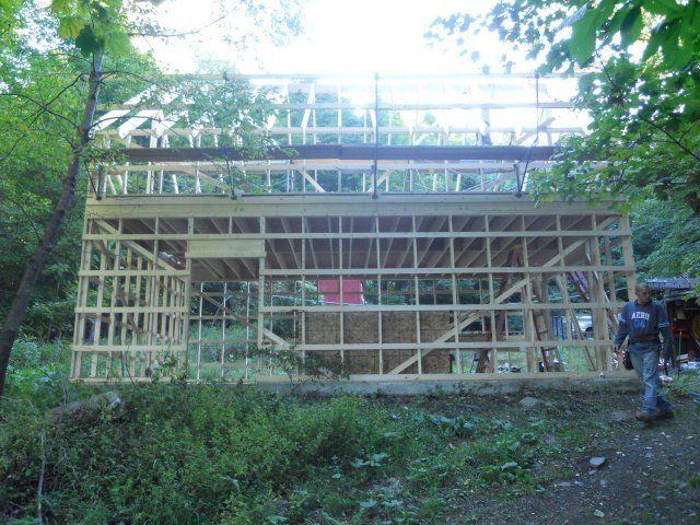 A wooden structure is being built in the woods