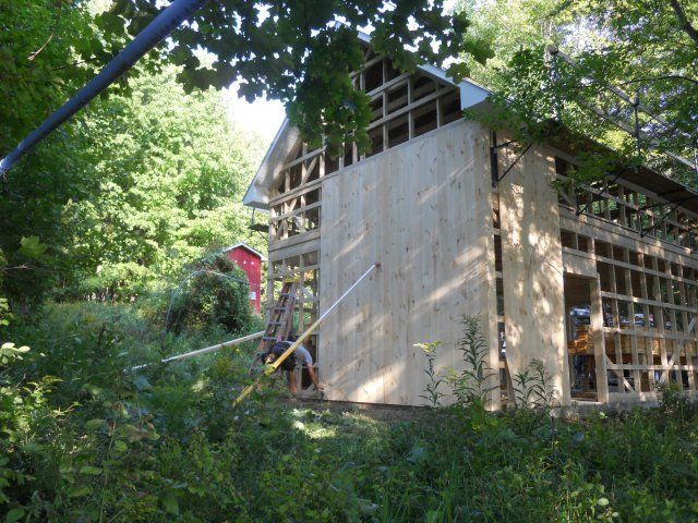 A wooden house is being built in the woods