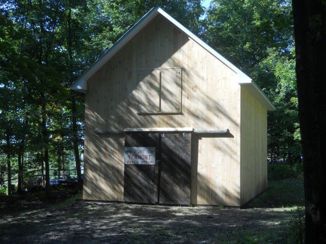 A shed with a sign on the door that says 