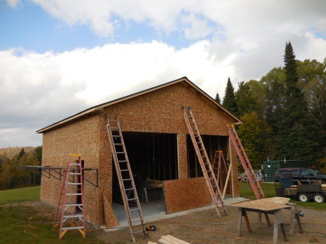 A garage being built with ladders and a table