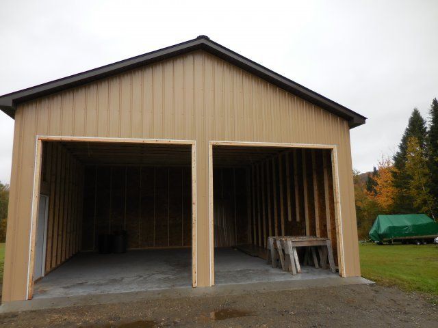 A garage that is being built with the doors open