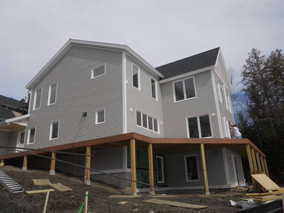 A large house with a wooden deck underneath it