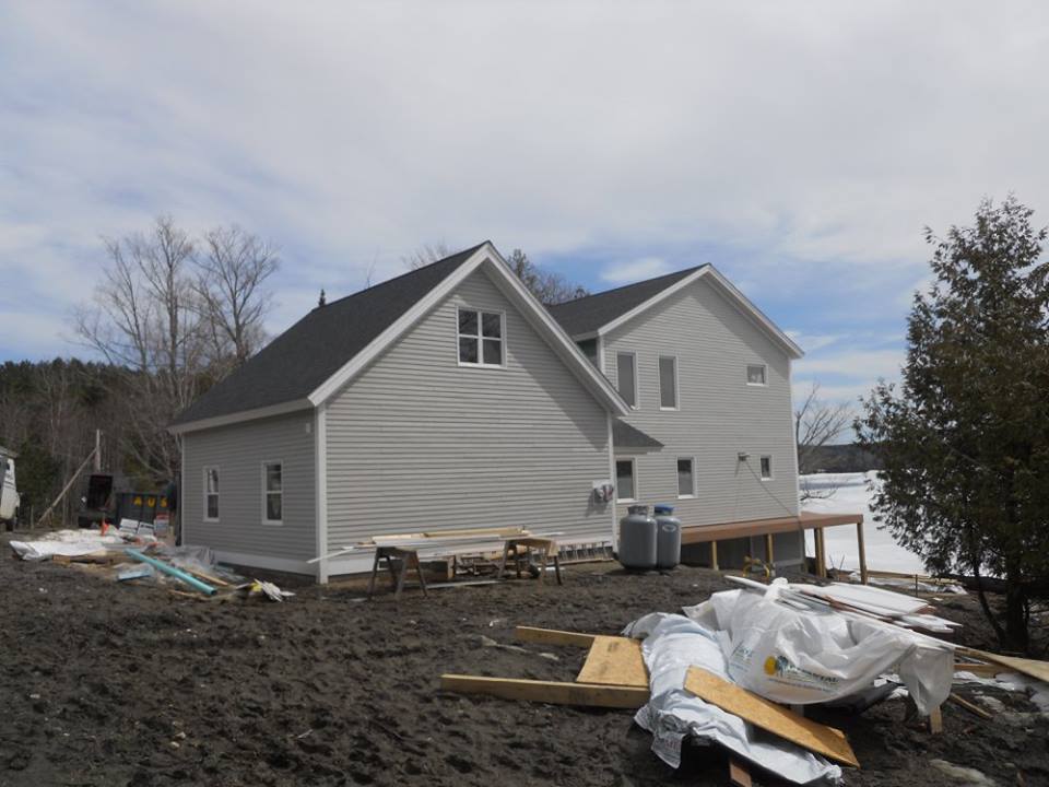 A house is being built in the middle of a dirt field