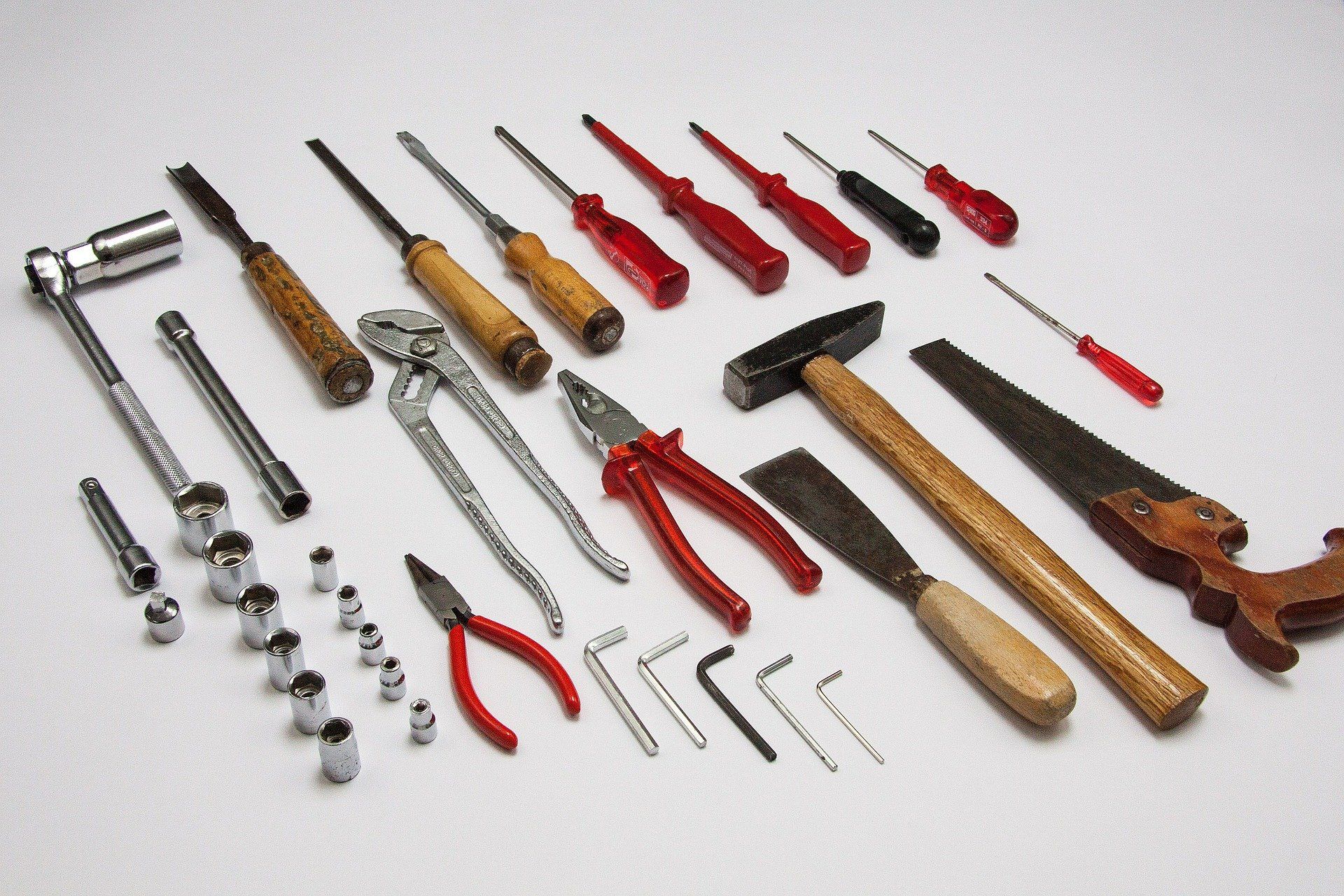 variety of tools laid out on a white table