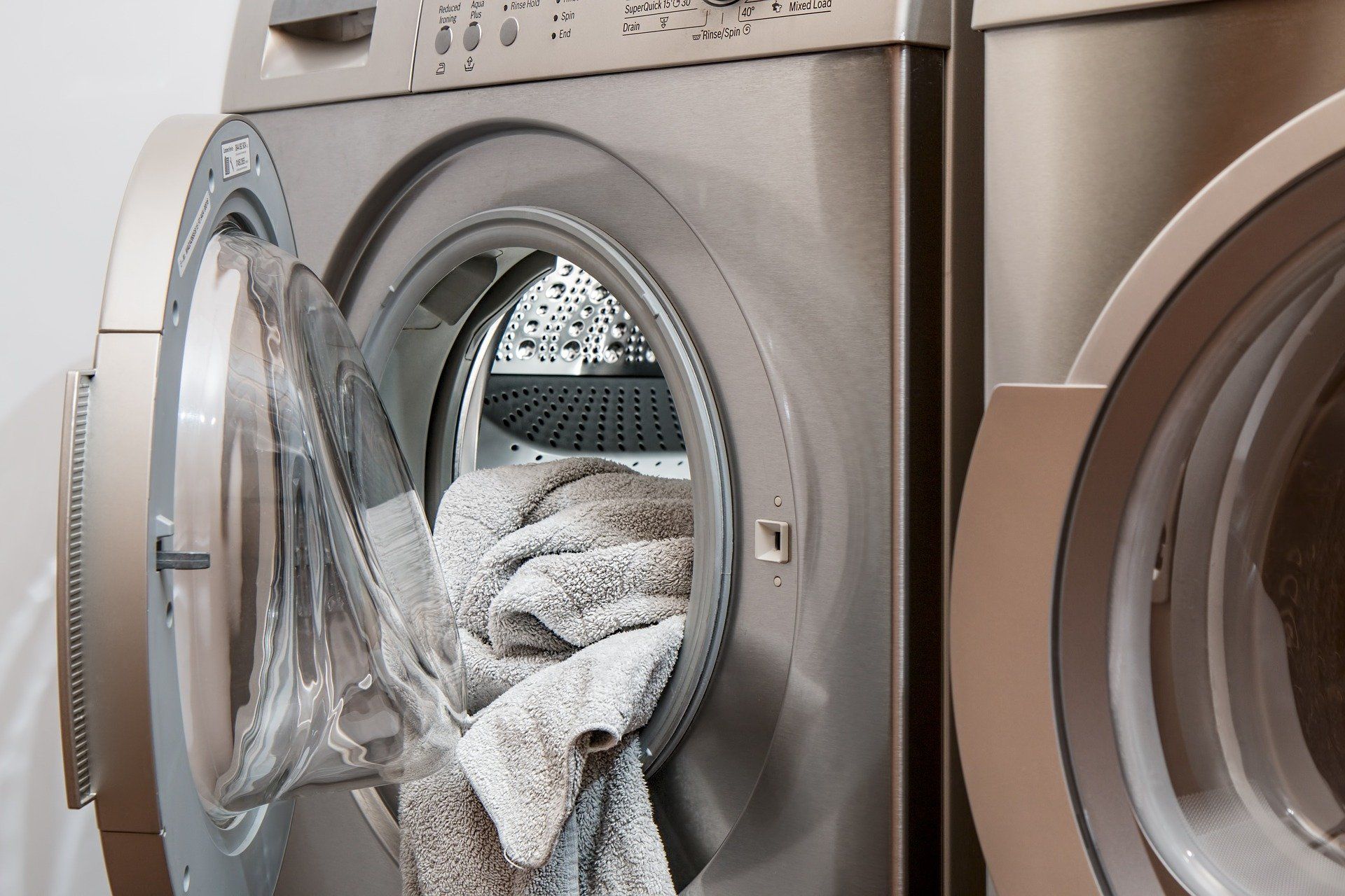 dryer with door open and towels inside