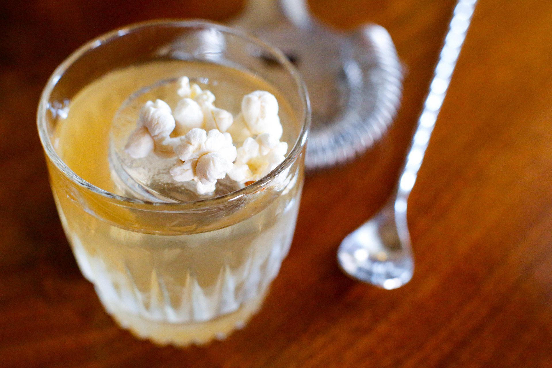 classic cocktail topped with a few kernels of popcorn