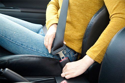 Woman Fastening Her Seat Belt