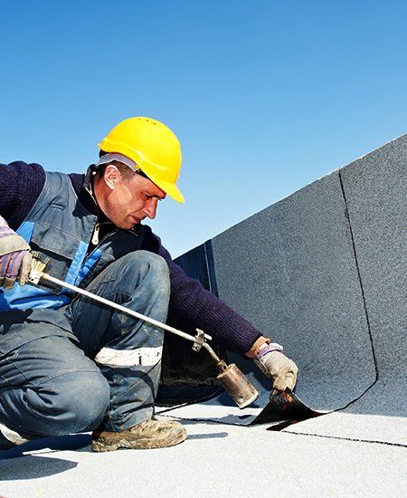 Experienced Roofing Service  — Man Installing Commercial Roof in Oakland, CA