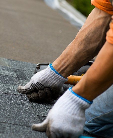Quality Roofing Materials  — Man Repairing Roof in Oakland, CA