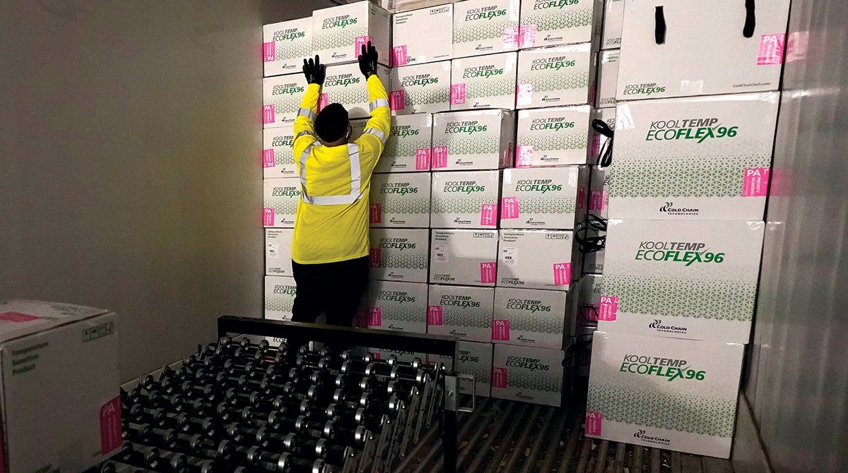 Boxes containing the Moderna COVID-19 vaccine are loaded into a truck for shipping. (Paul Sancya/Associated Press)