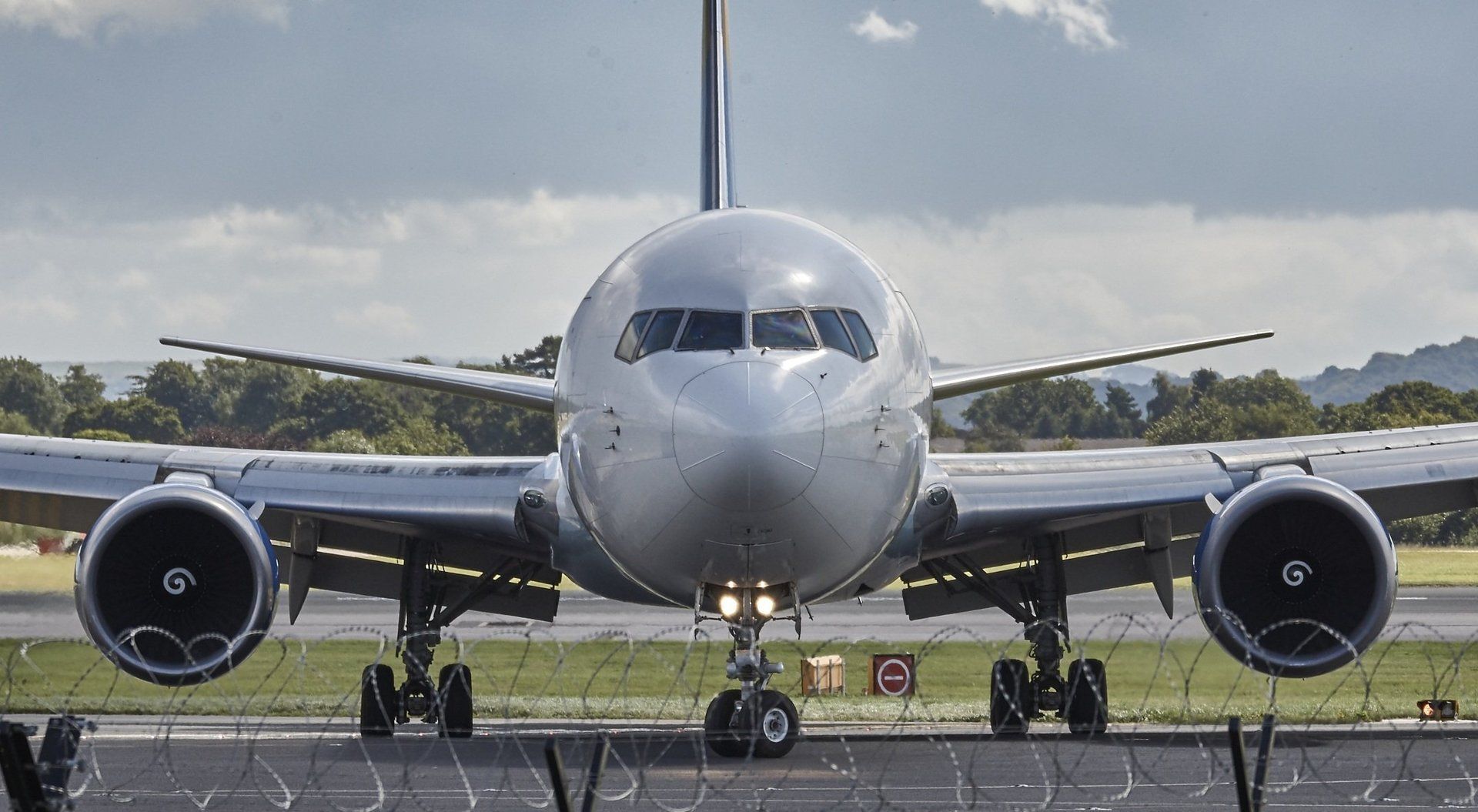 A large passenger jet is sitting on top of an airport runway.
