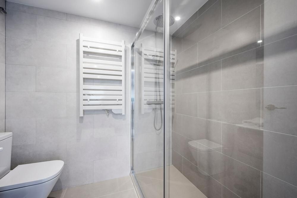 A Bathroom with A Toilet, Shower, and Towel Rack — Grafton Glass in South Grafton, NSW
