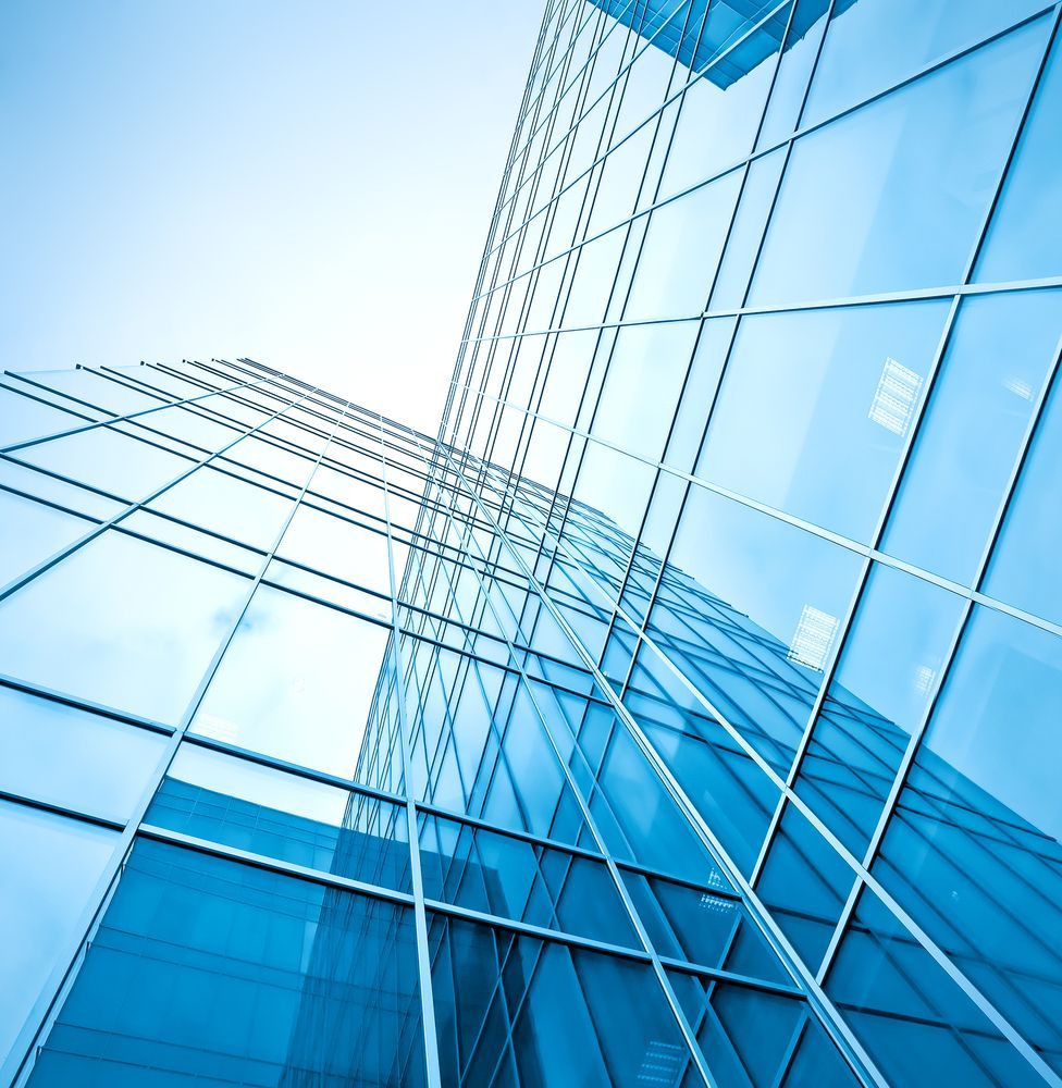 Modern glass office building with reflective blue windows looking upwards towards the sky. — Grafton Glass in South Grafton, NSW