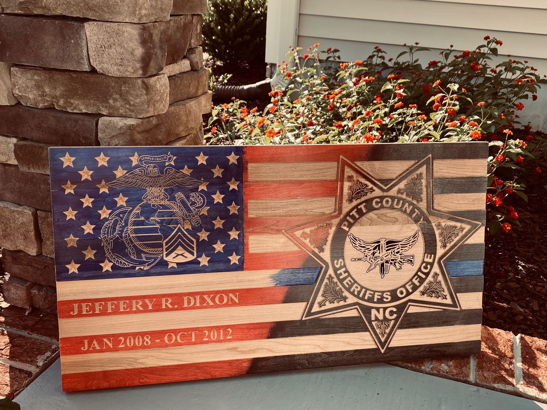 A wooden flag with a sheriff 's badge on it