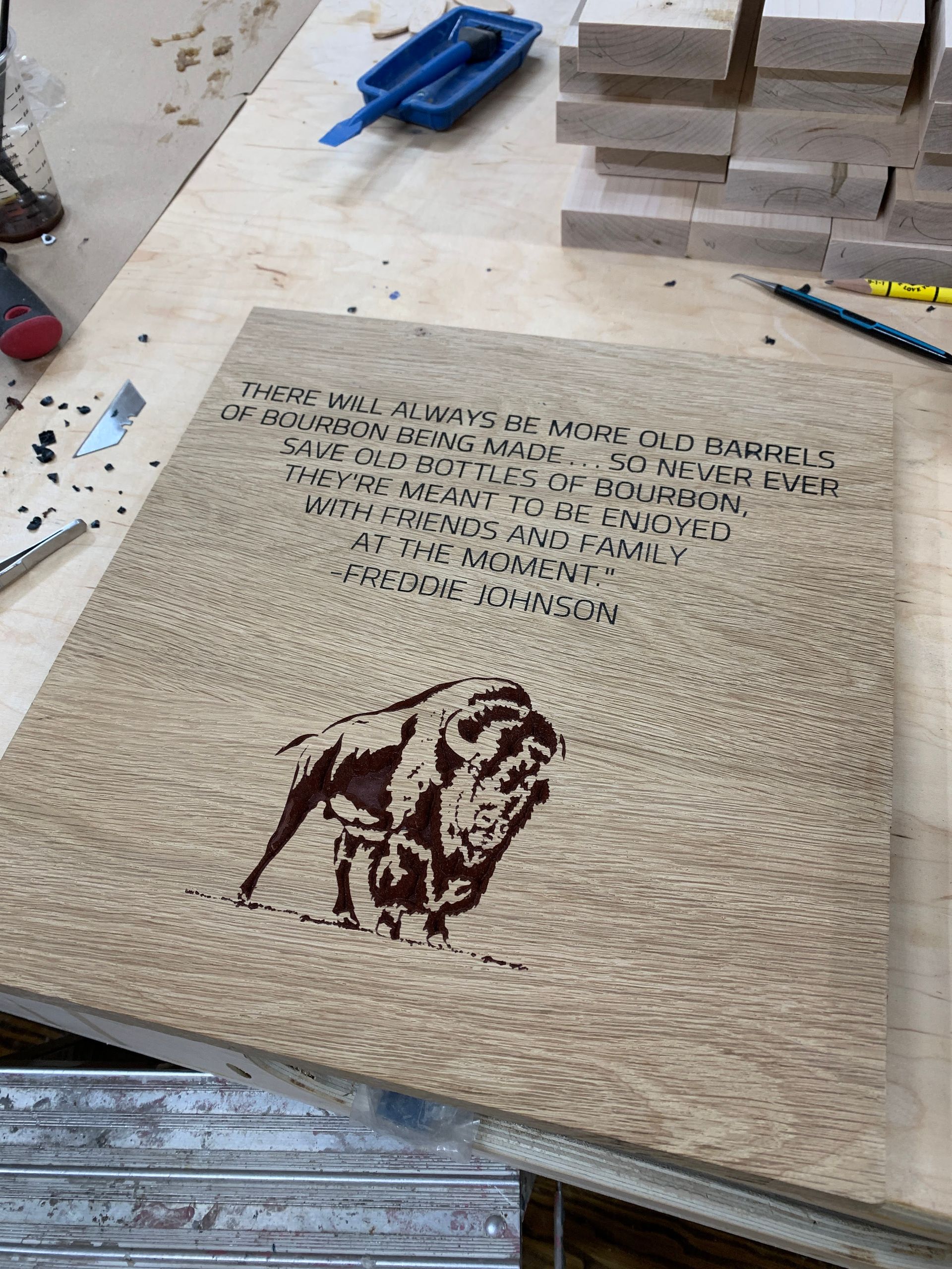 A piece of wood with a picture of a buffalo on it