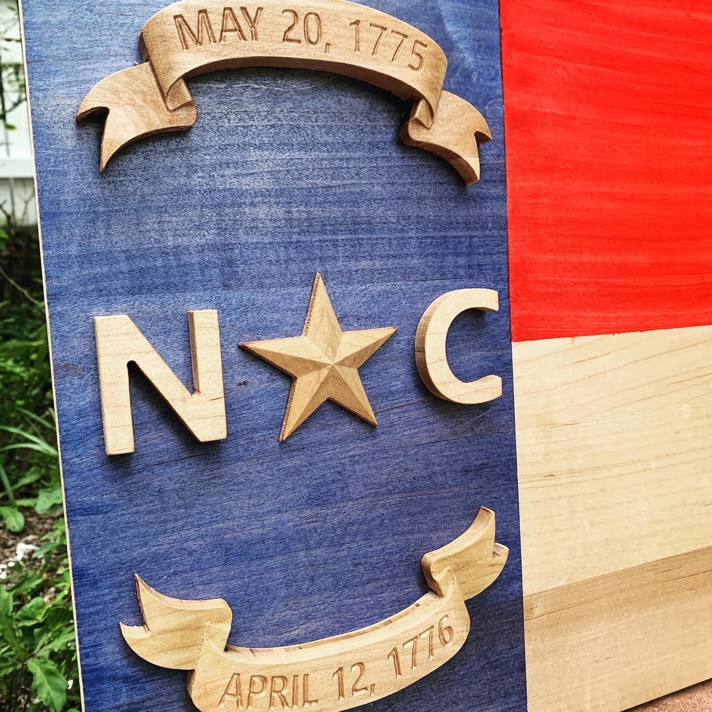 A wooden sign with the letters n and c on it