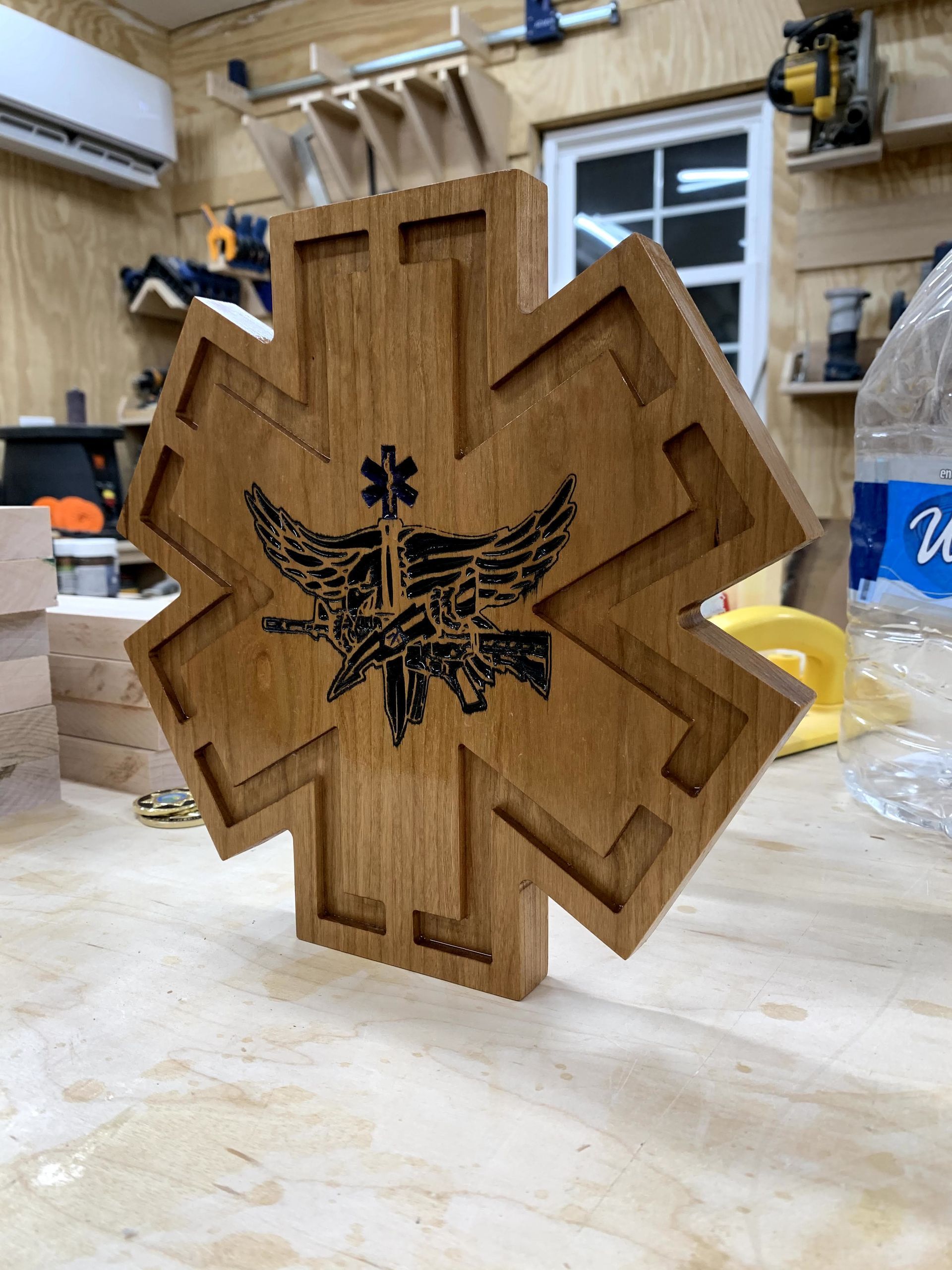 A wooden star of life is sitting on a wooden table.