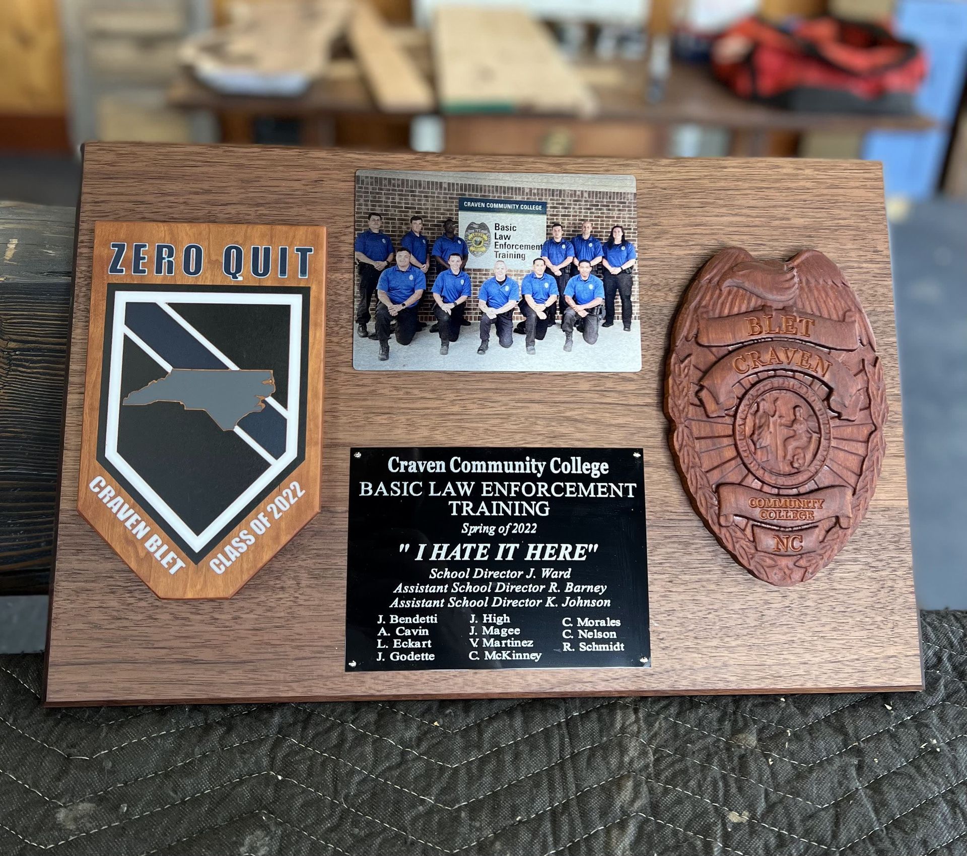 A wooden plaque with a picture of a police badge on it