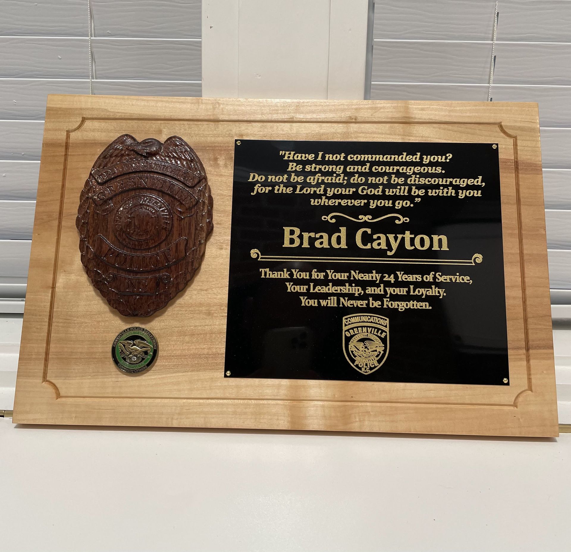A wooden plaque with the name brad caxton on it