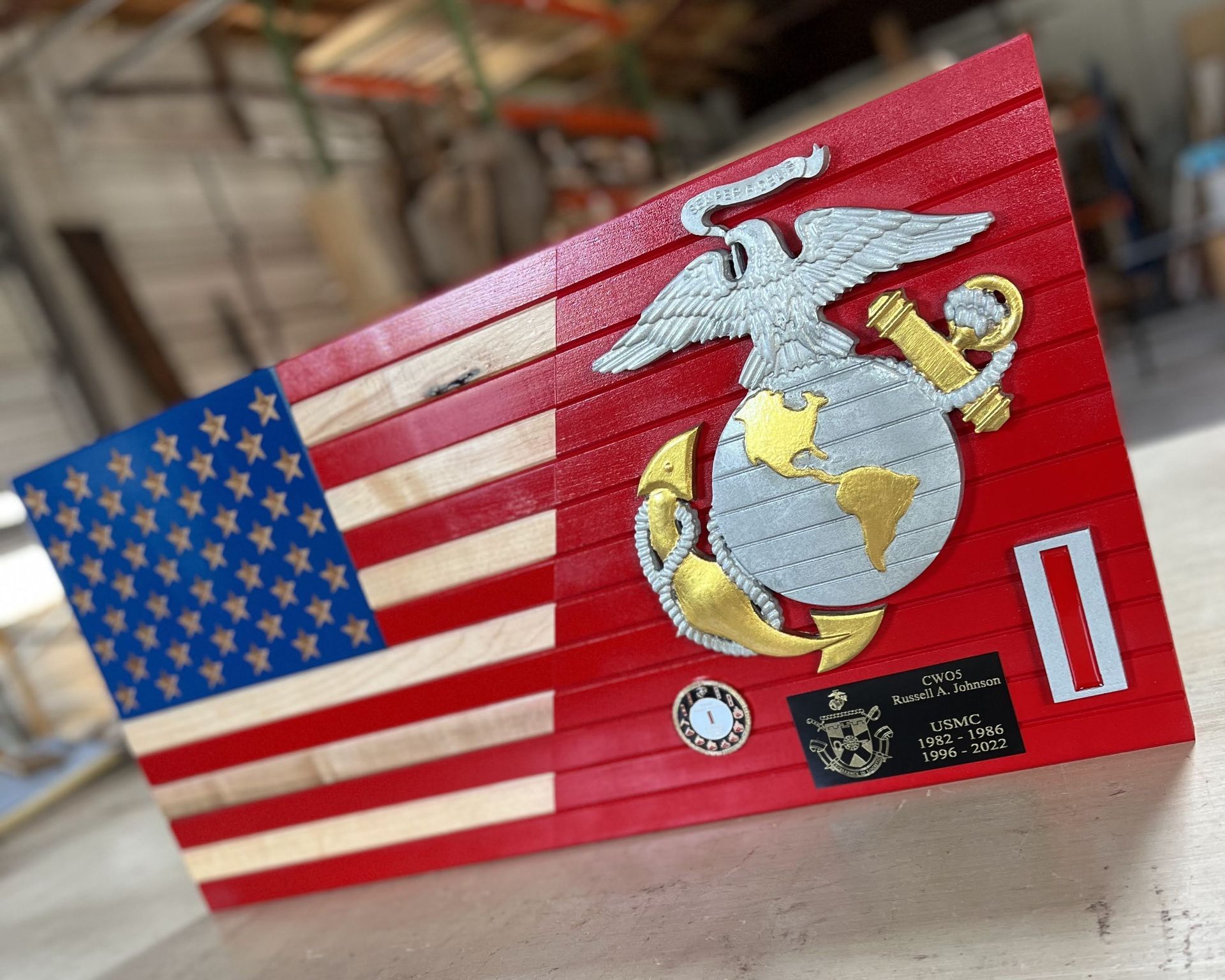 A wooden american flag with a marine emblem on it