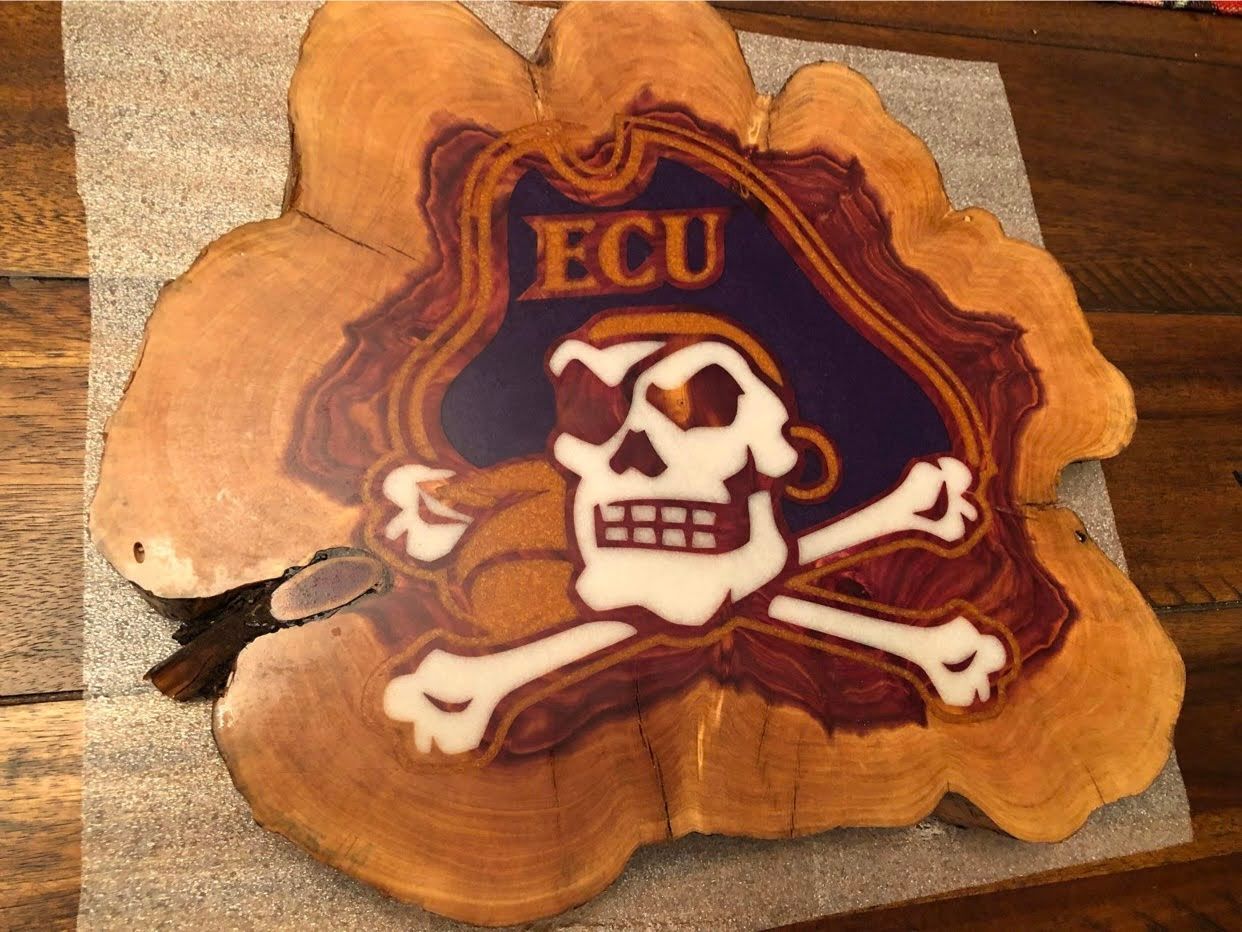 A piece of wood with ecu written on it